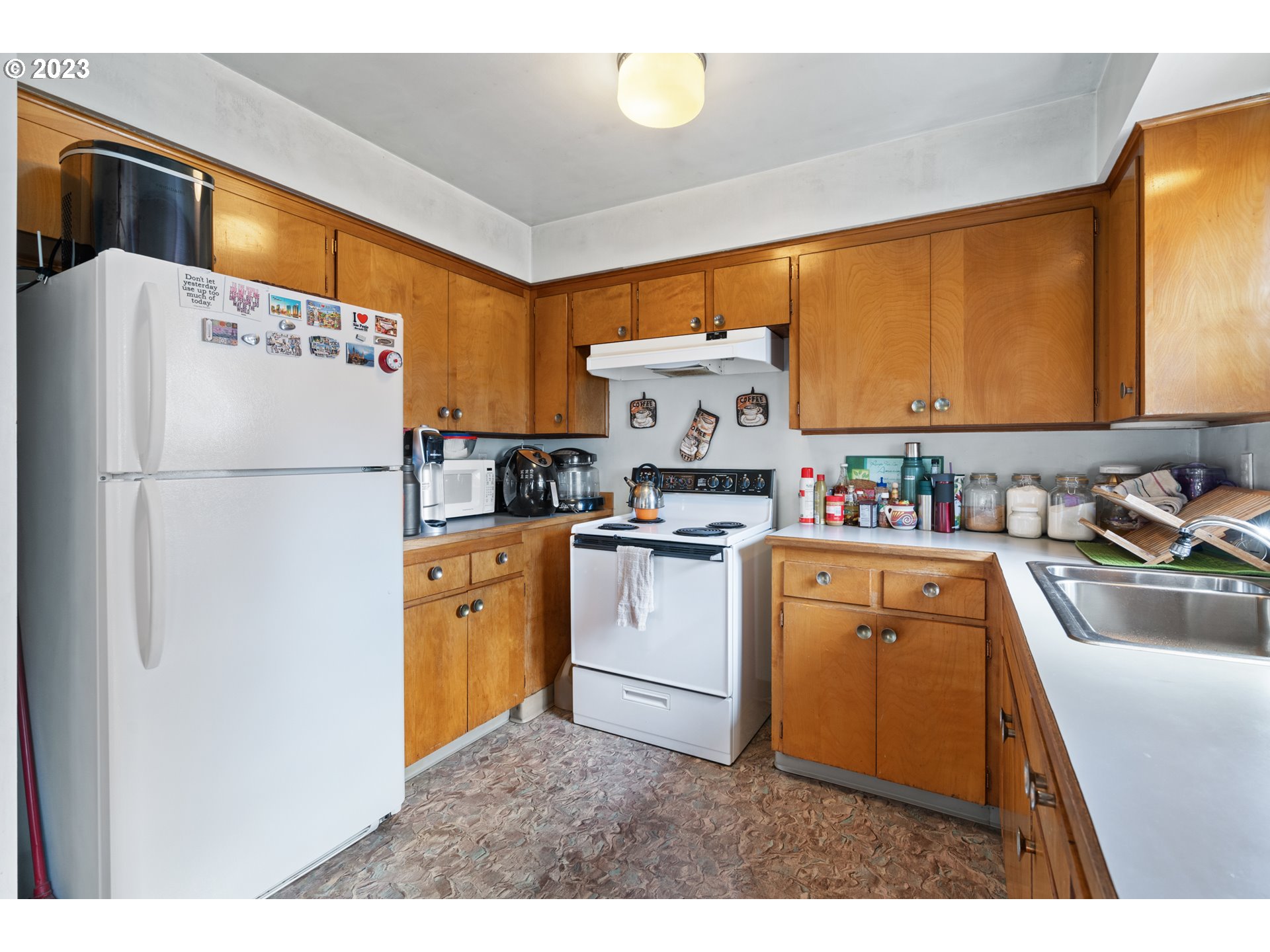 3832 North Kilpatrick Street Portland, OR 97217 - Photo 21 of 34 a kitchen with refrigerator a sink and cabinets