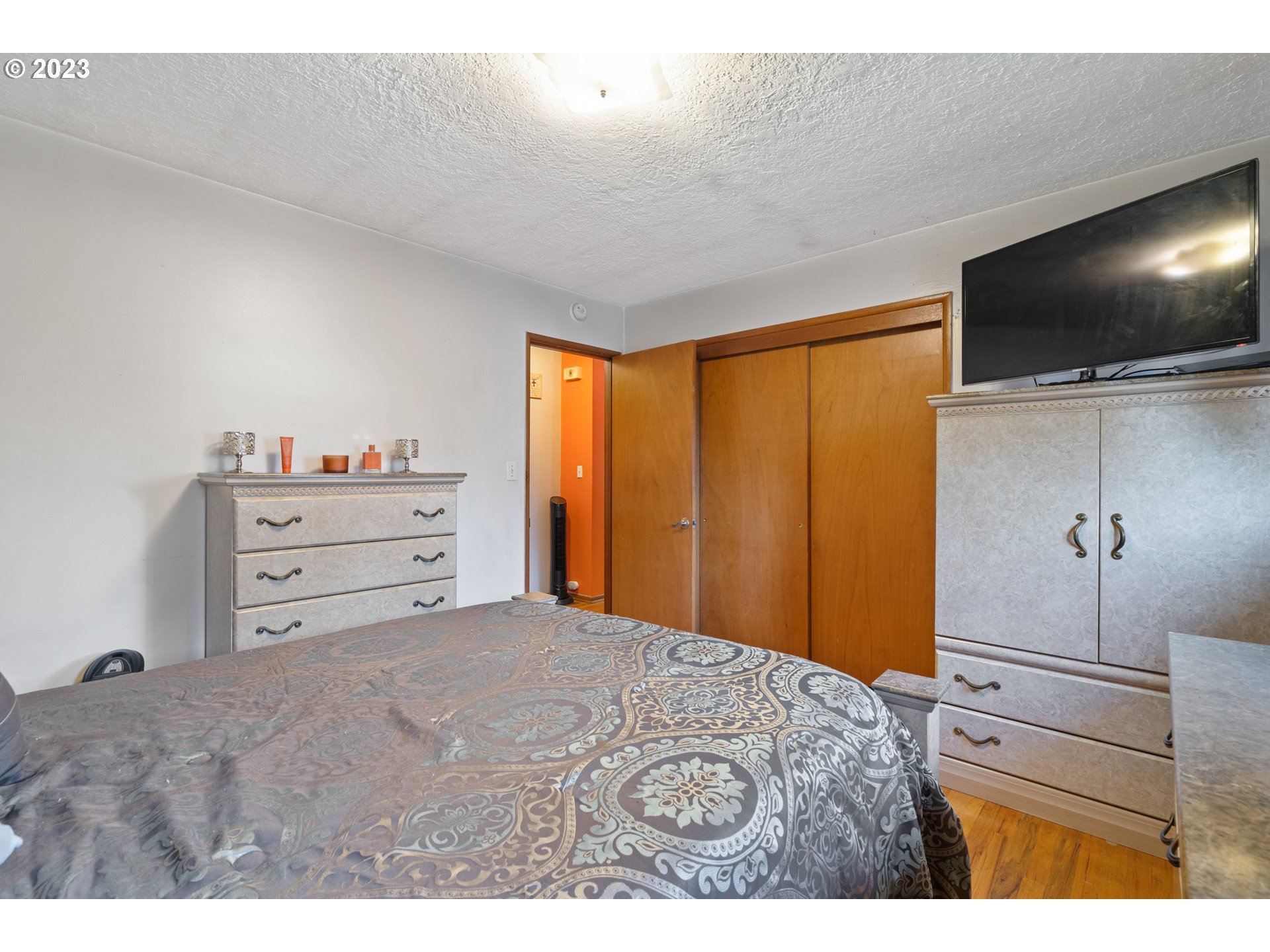 3832 North Kilpatrick Street Portland, OR 97217 - Photo 26 of 34 a bedroom with a bed and a flat screen tv