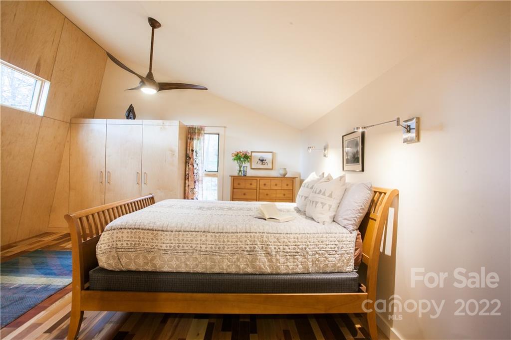 450 Lakey Gap Road Black Mountain, NC 28711 - Photo 18 of 40 a bedroom with a bed window and lamp