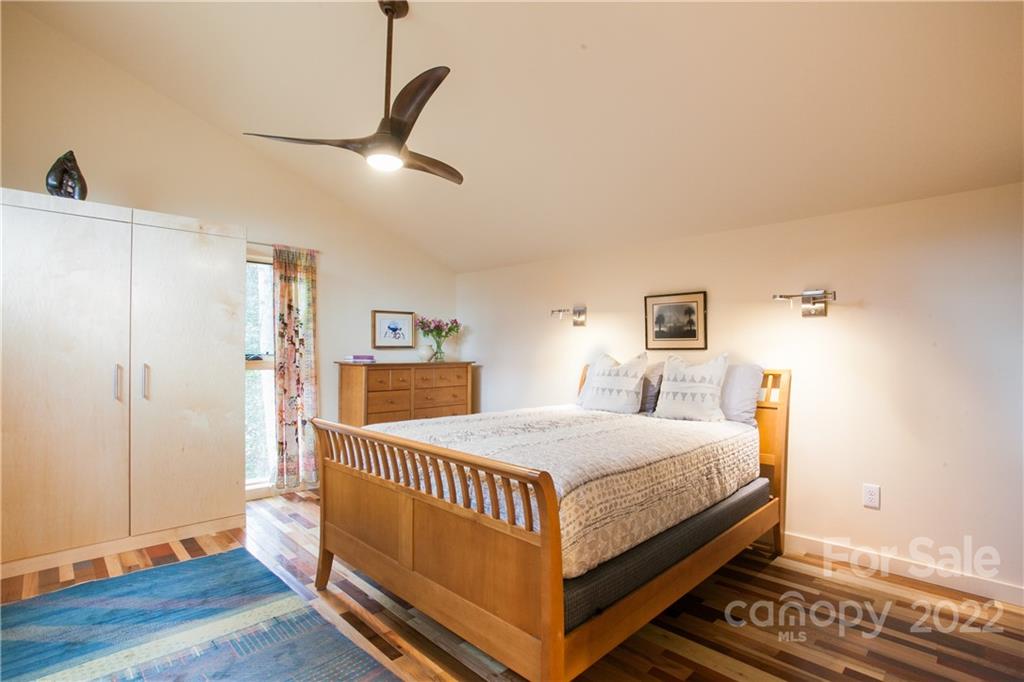 450 Lakey Gap Road Black Mountain, NC 28711 - Photo 19 of 40 a bedroom with a bed and wooden floor