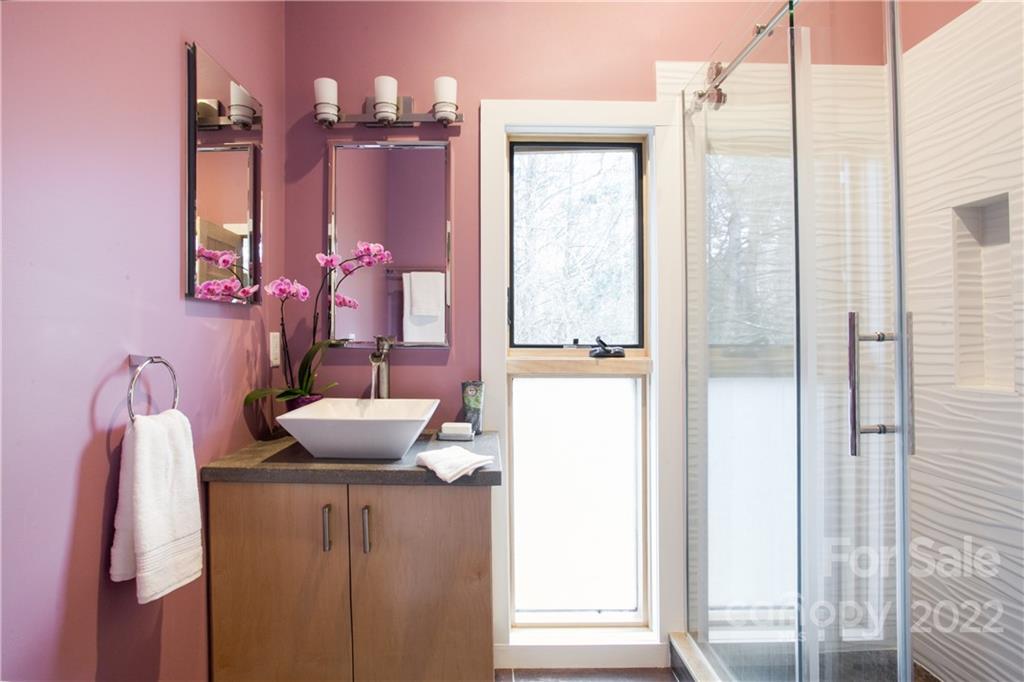 450 Lakey Gap Road Black Mountain, NC 28711 - Photo 21 of 40 a bathroom with a mirror and shower