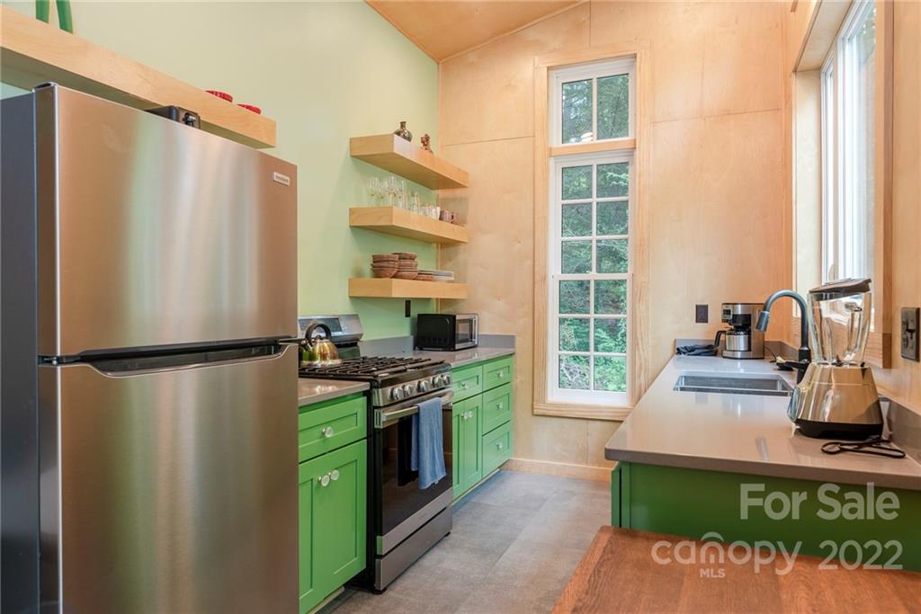 450 Lakey Gap Road Black Mountain, NC 28711 - Photo 29 of 40 a kitchen with a stove a refrigerator and a stove