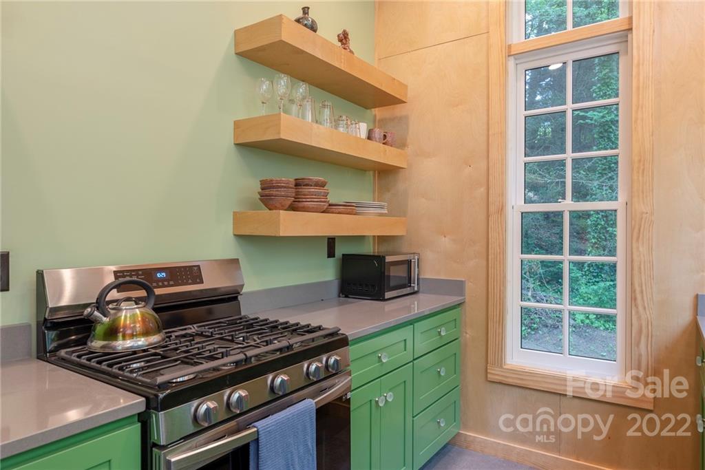 450 Lakey Gap Road Black Mountain, NC 28711 - Photo 30 of 40 a kitchen with stainless steel appliances granite countertop a stove and a sink