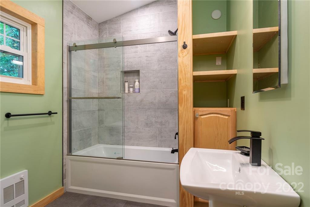 450 Lakey Gap Road Black Mountain, NC 28711 - Photo 34 of 40 a bathroom with a tub and a shower