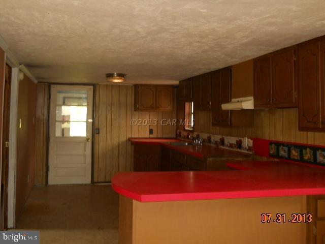9132 Bethel Road Willards, MD 21874 - Photo 3 of 18 a kitchen with a refrigerator and a sink