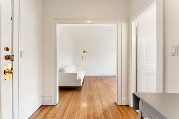 a view of living room with furniture and wooden floor