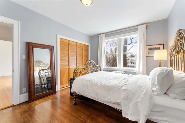 a bedroom with a bed and a large window