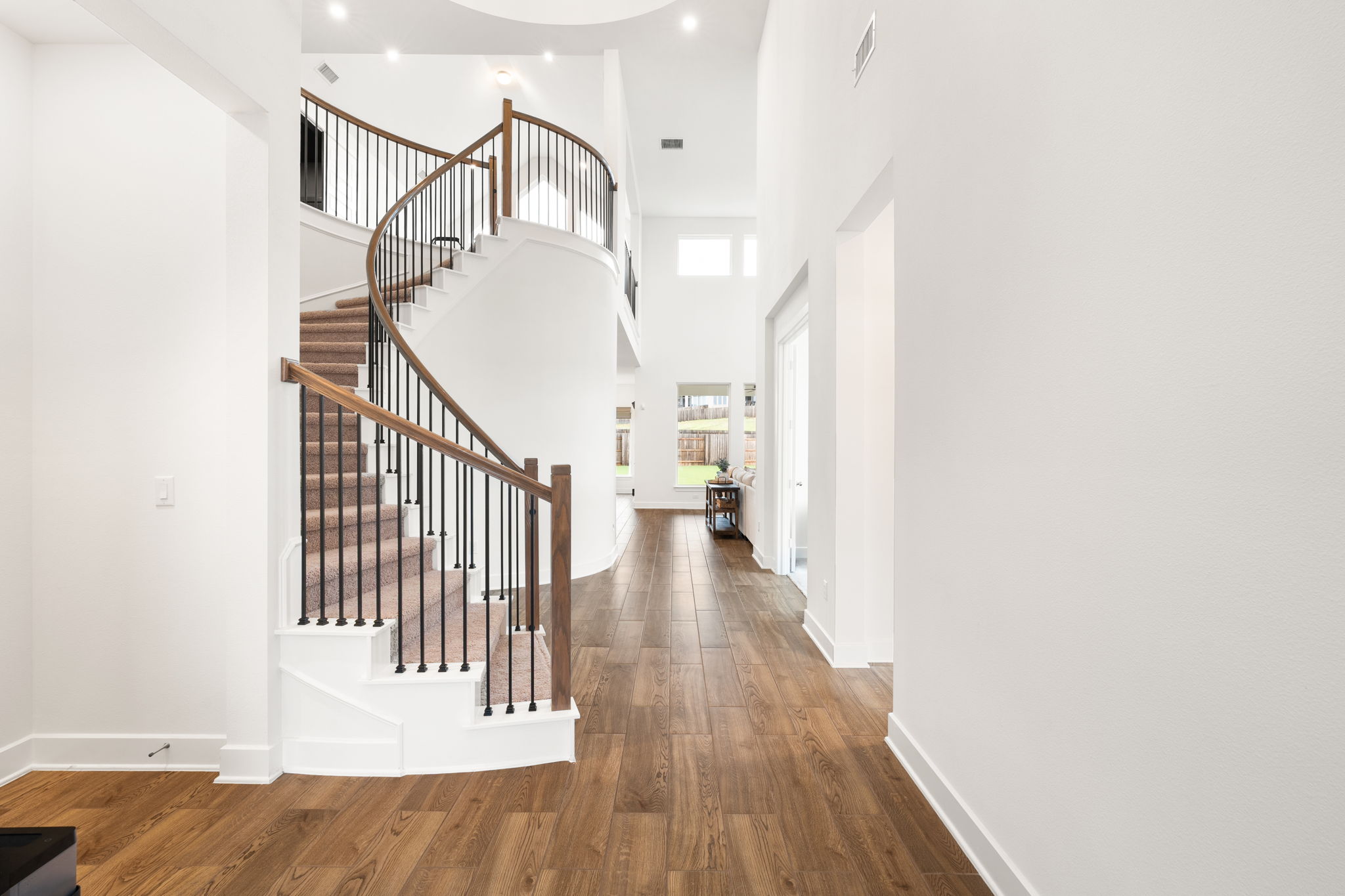515 Watershield Cove Georgetown, TX 78633 - Photo 5 of 40 A grand spiral staircase commands attention in this inviting, naturally illuminated foyer.