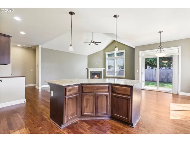 a kitchen with kitchen island a counter top space appliances and cabinets