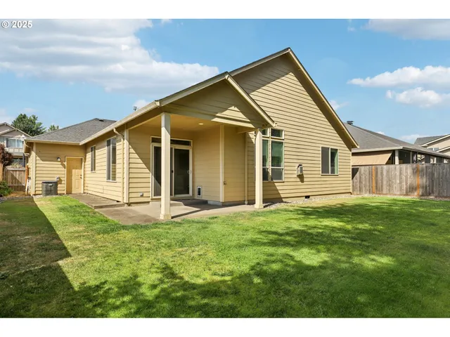 a view of a backyard with plants and a garden