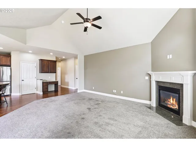 a view of an empty room with window and fireplace