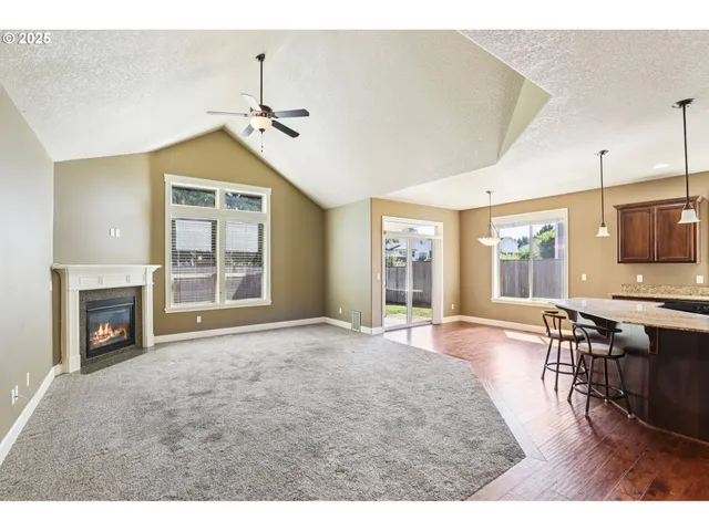a living room with furniture a fireplace and flat screen tv