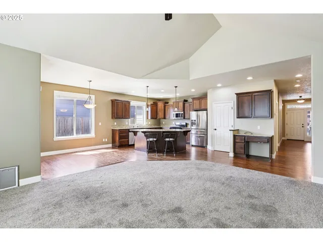 a living room with furniture and kitchen view