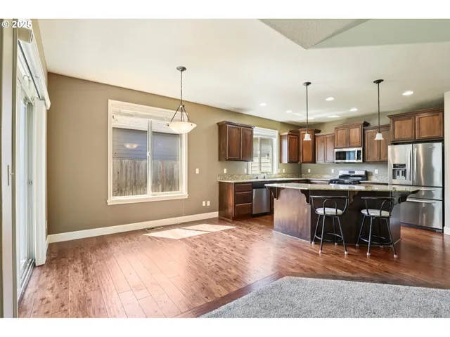 a large kitchen with a table and chairs