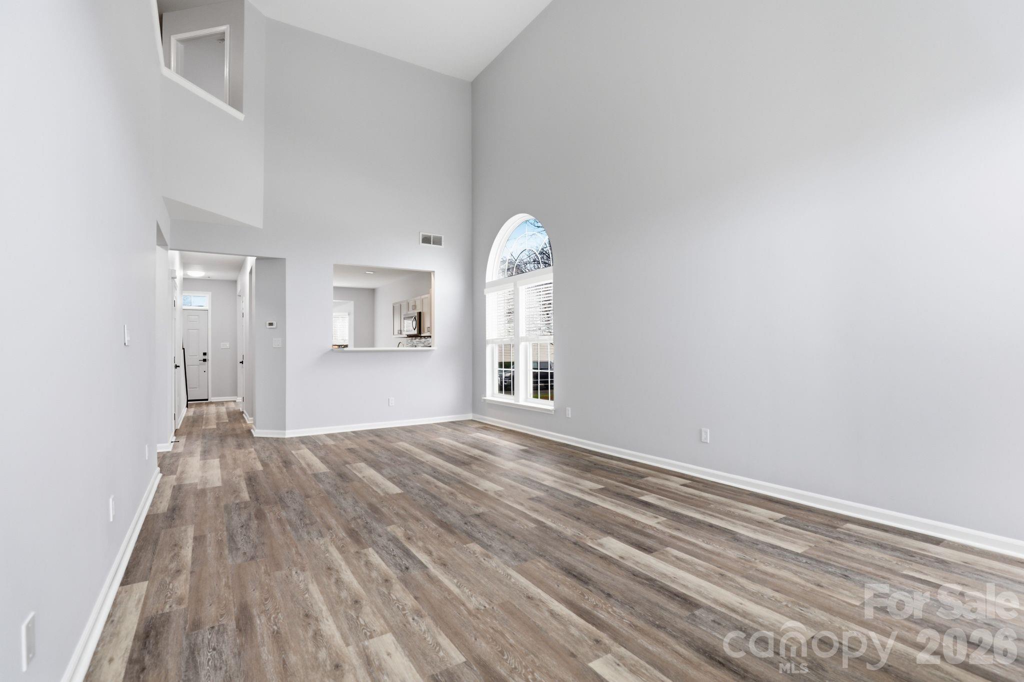 7978 Mariners Pointe Circle Denver, NC 28037 - Photo 12 of 37 a view of empty room with wooden floor and fan