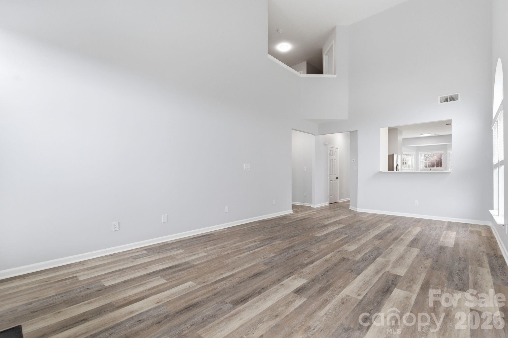 7978 Mariners Pointe Circle Denver, NC 28037 - Photo 13 of 37 an empty room with wooden floor and windows