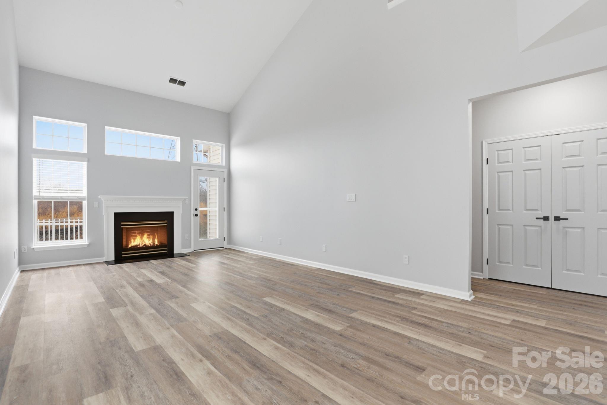 7978 Mariners Pointe Circle Denver, NC 28037 - Photo 15 of 37 a view of an empty room with wooden floor and a window
