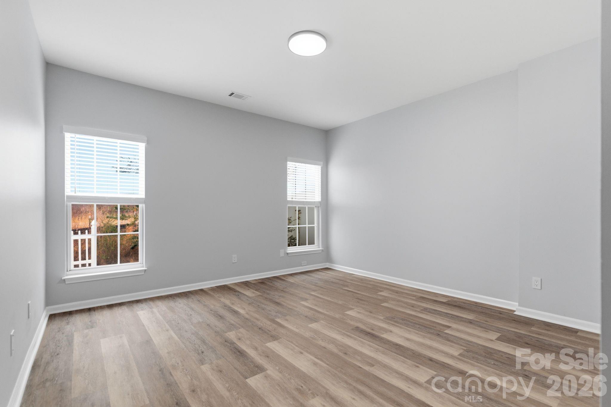 7978 Mariners Pointe Circle Denver, NC 28037 - Photo 18 of 37 an empty room with wooden floor and windows