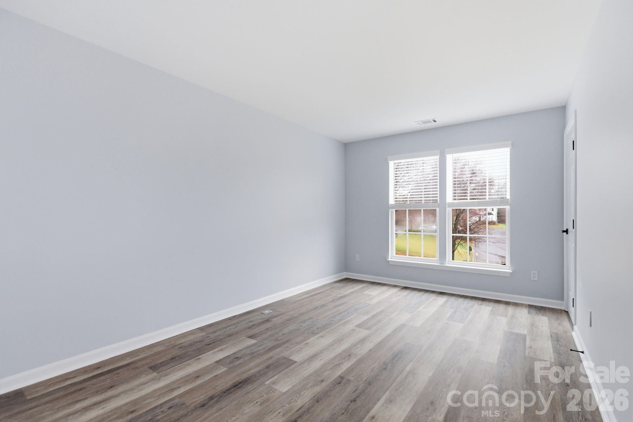 7978 Mariners Pointe Circle Denver, NC 28037 - Photo 24 of 37 an empty room with wooden floor and windows