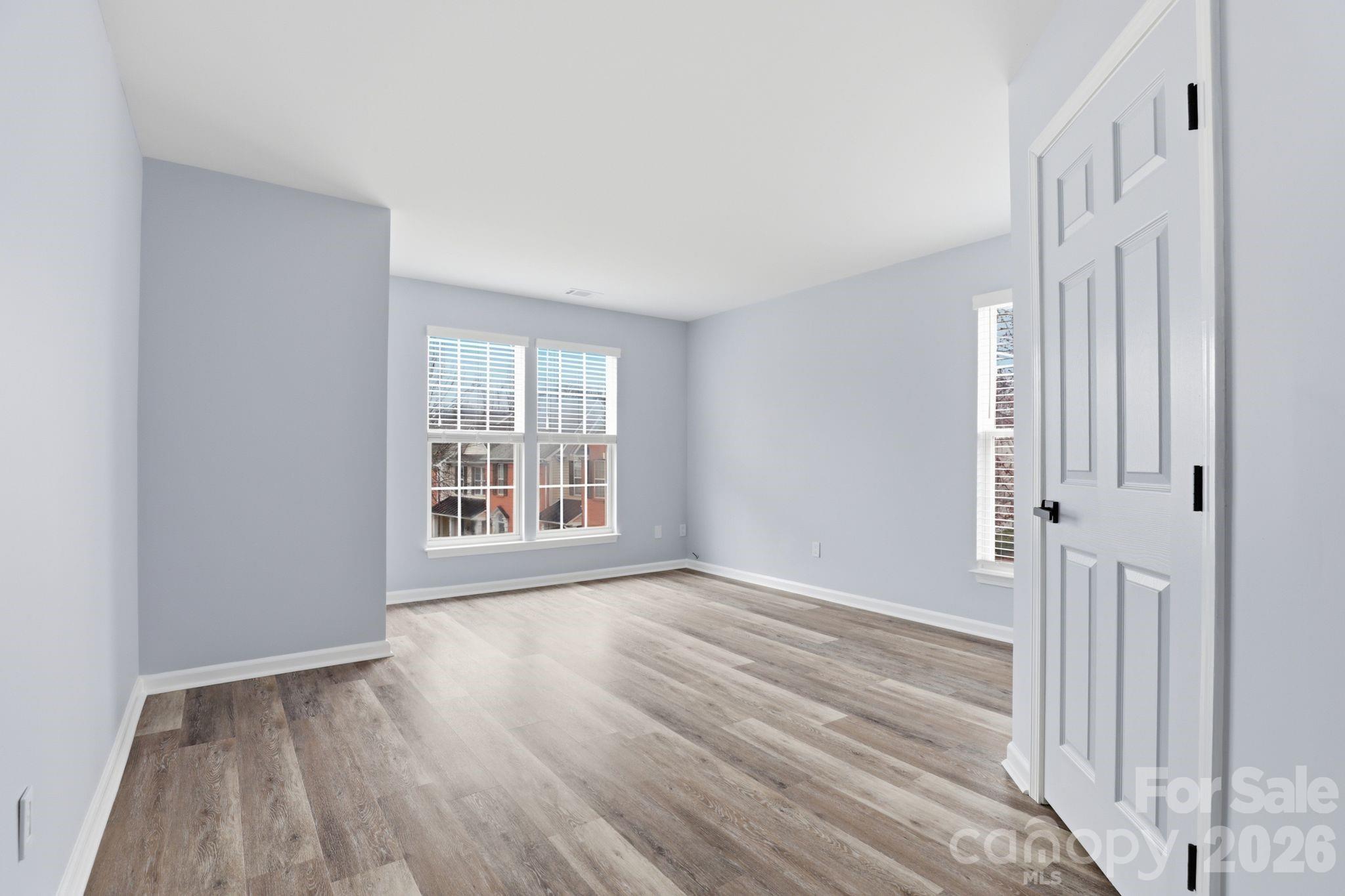 7978 Mariners Pointe Circle Denver, NC 28037 - Photo 29 of 37 a view of an empty room with wooden floor and a window