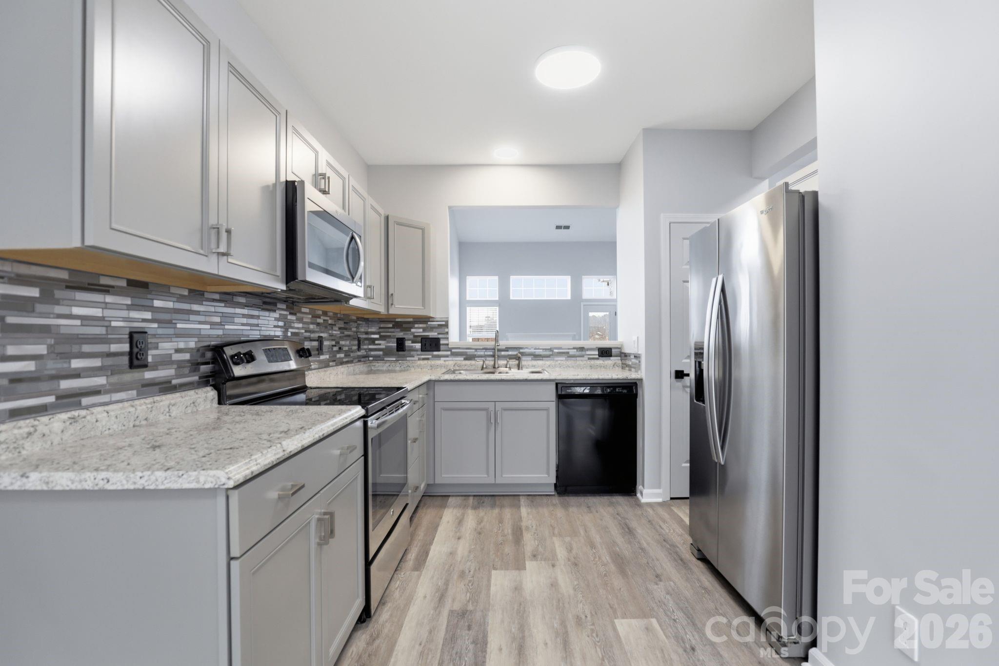 7978 Mariners Pointe Circle Denver, NC 28037 - Photo 3 of 37 a kitchen with stainless steel appliances granite countertop a refrigerator sink and stove