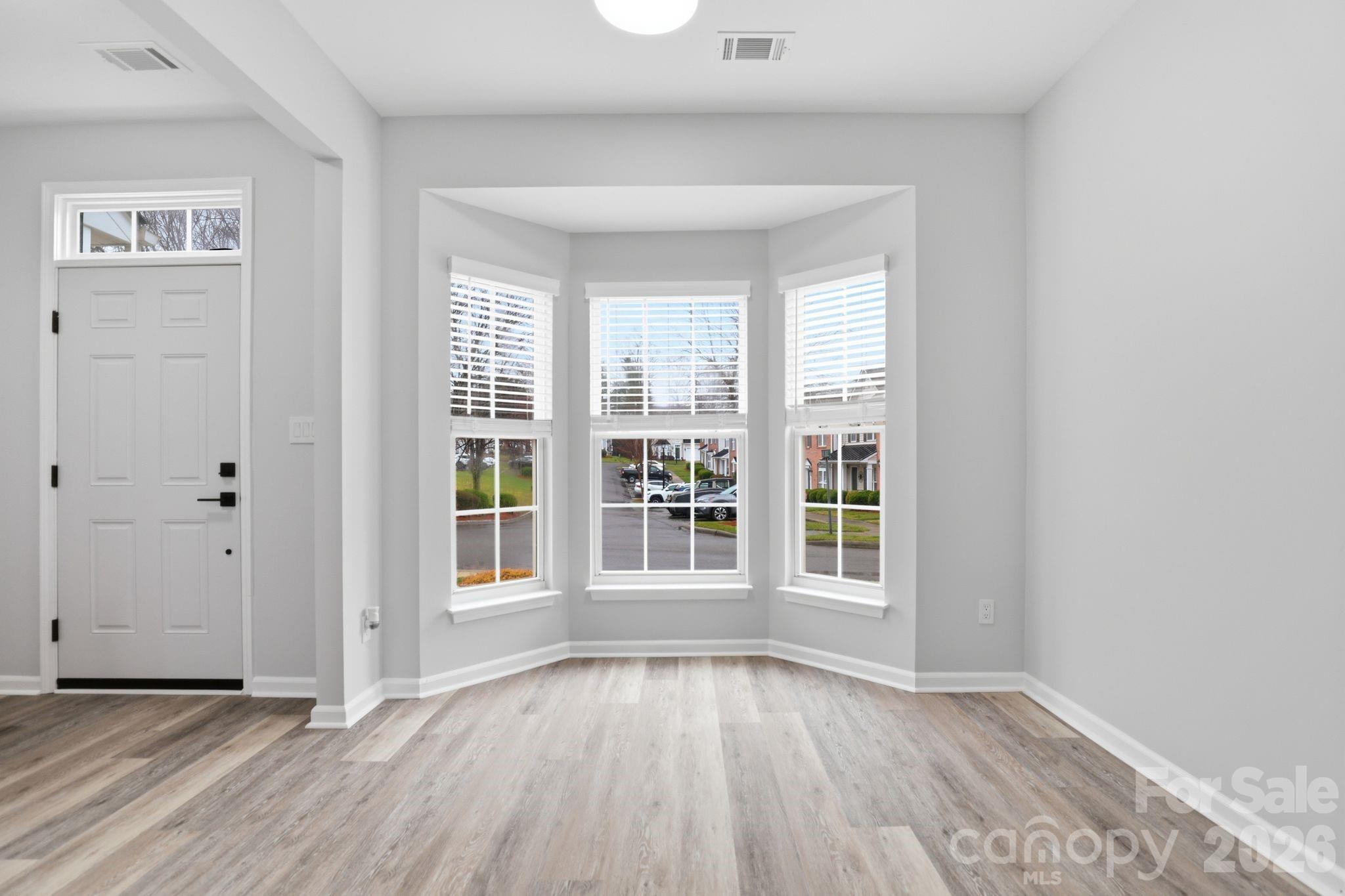 7978 Mariners Pointe Circle Denver, NC 28037 - Photo 7 of 37 an empty room with wooden floor and windows