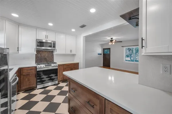 a kitchen with stainless steel appliances a stove a sink and a refrigerator