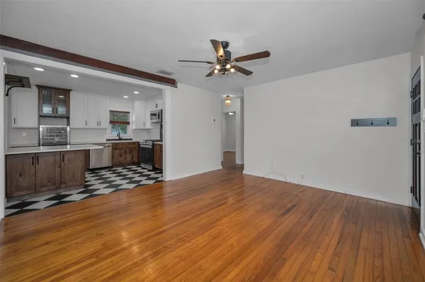 wooden floor in an empty room with a window