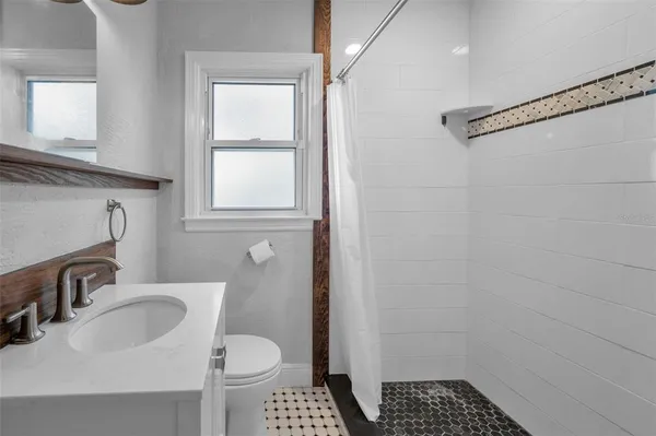 a bathroom with a sink toilet and shower