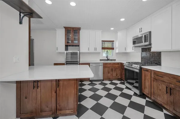 a kitchen with a sink a stove a microwave and cabinets