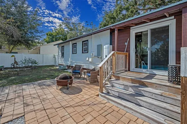 a view of backyard with deck and garden