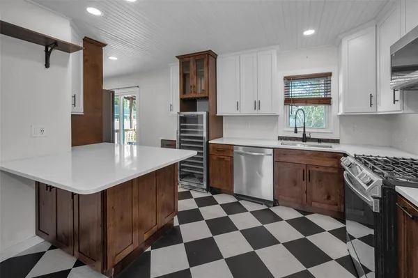 a kitchen with a sink a stove and cabinets