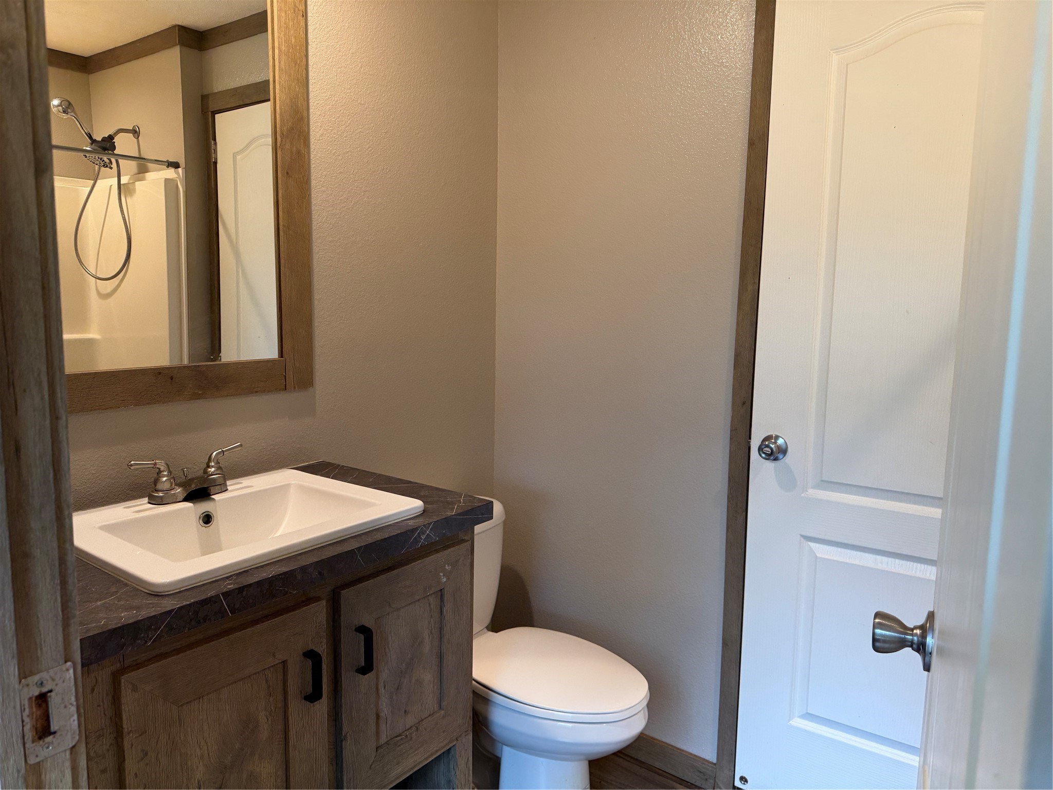105 Saddle Surrey Road Coldspring, TX 77331 - Photo 42 of 48 a bathroom with a toilet sink and mirror