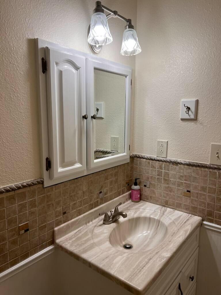 3006 County Road 3500 Lubbock, TX 79403 - Photo 11 of 23 a bathroom with a sink and a mirror
