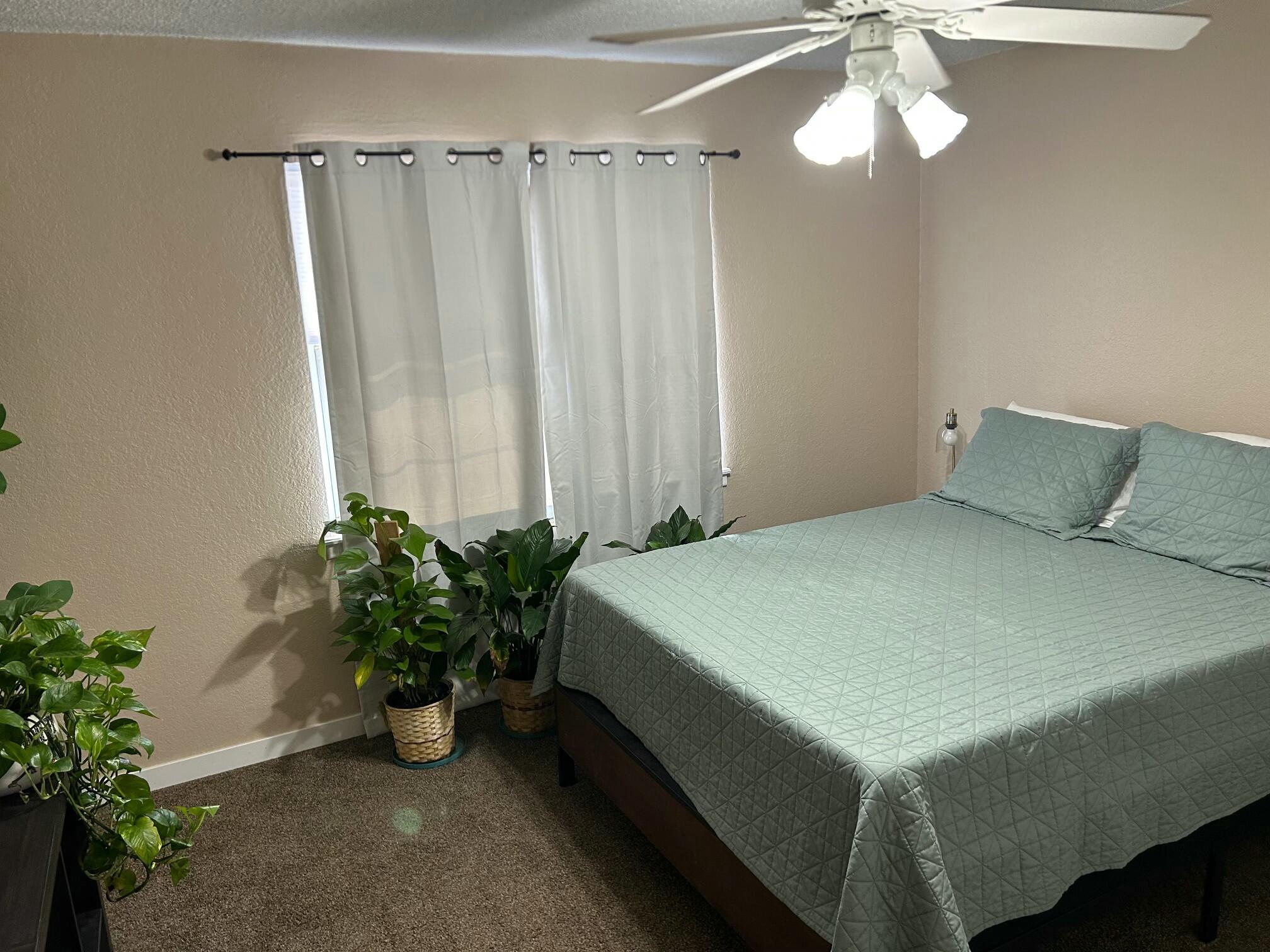 3006 County Road 3500 Lubbock, TX 79403 - Photo 14 of 23 a bedroom with a bed and a chandelier