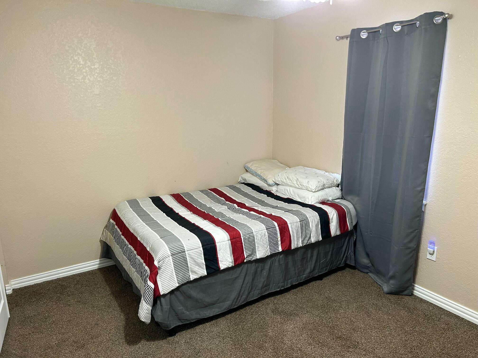 3006 County Road 3500 Lubbock, TX 79403 - Photo 16 of 23 a bedroom with a bed and cabinet