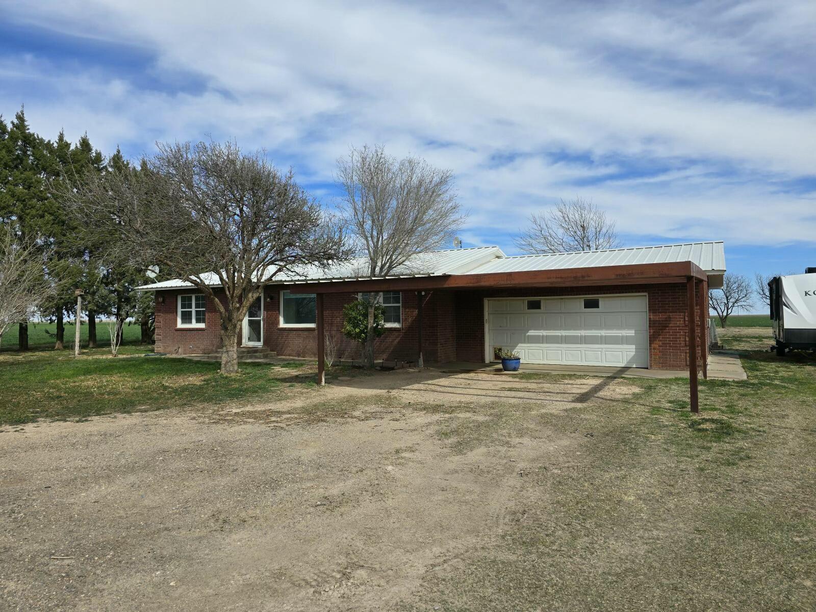 3006 County Road 3500 Lubbock, TX 79403 - Photo 2 of 23 a view of a house with a yard