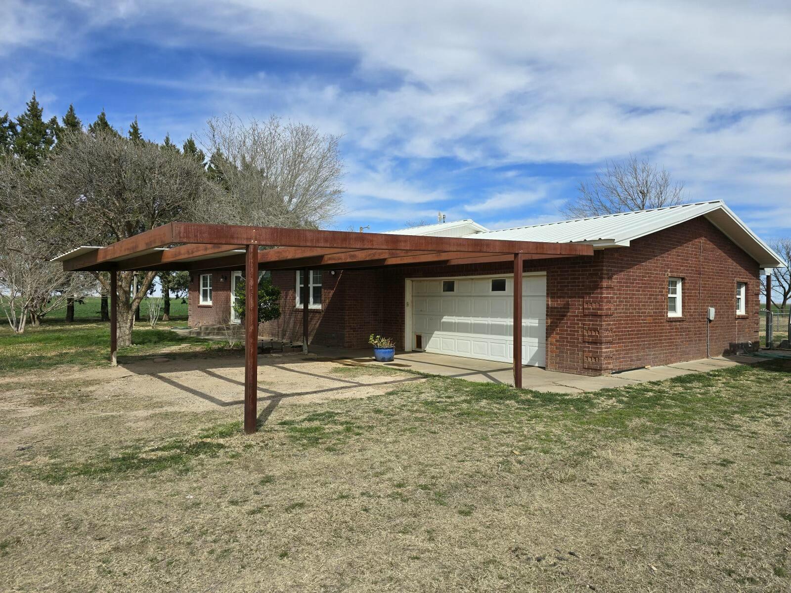 3006 County Road 3500 Lubbock, TX 79403 - Photo 4 of 23 a front view of a house with a yard