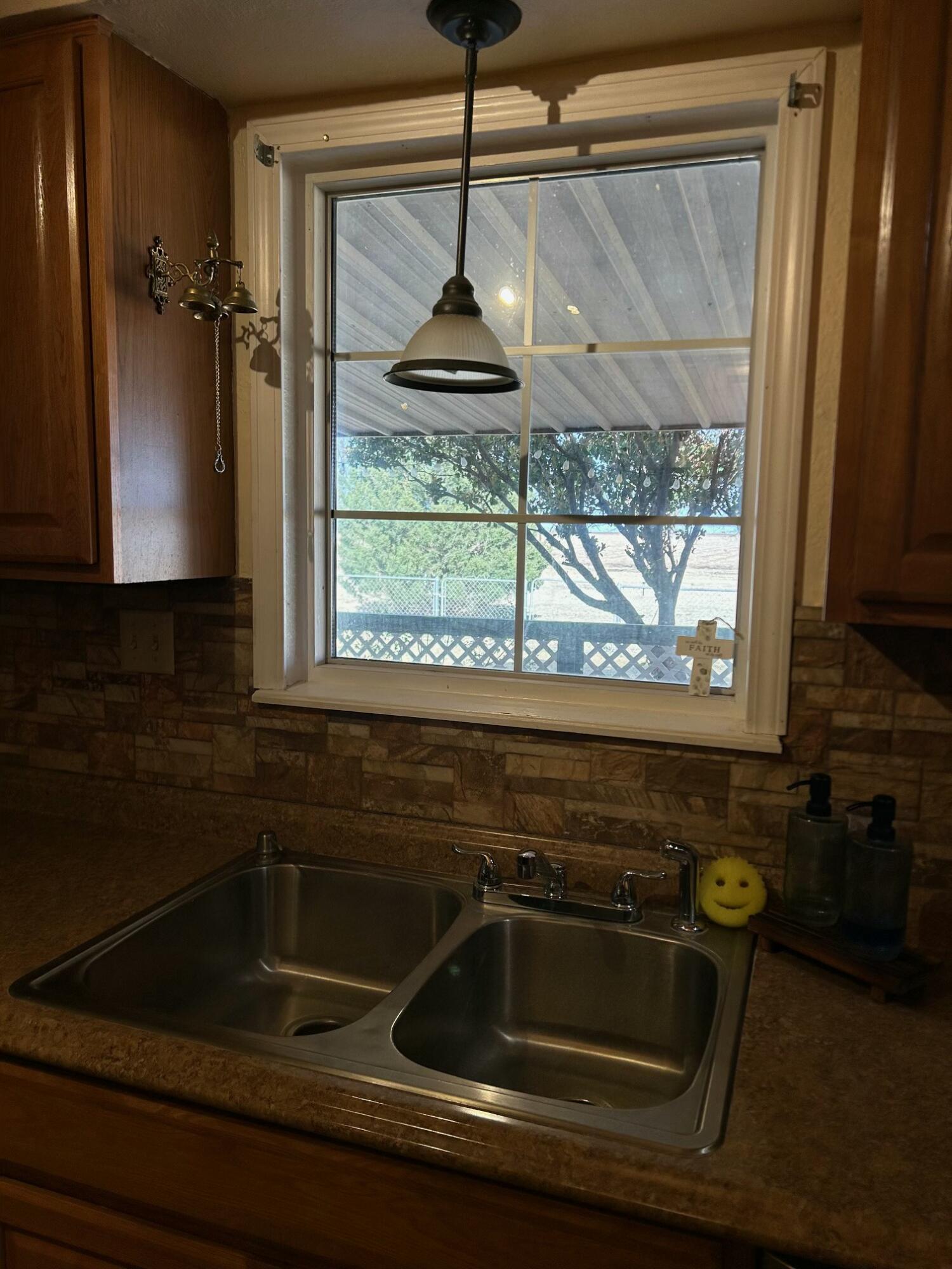 3006 County Road 3500 Lubbock, TX 79403 - Photo 9 of 23 a kitchen with a sink and a window