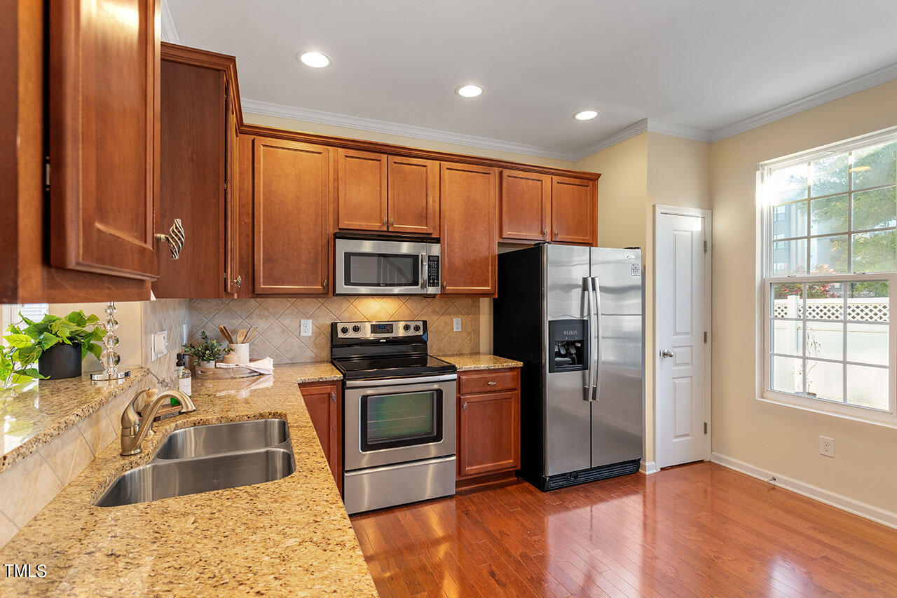 864 Cupola Drive Raleigh, NC 27603 - Photo 14 of 26 Granite counters & pantry on far right