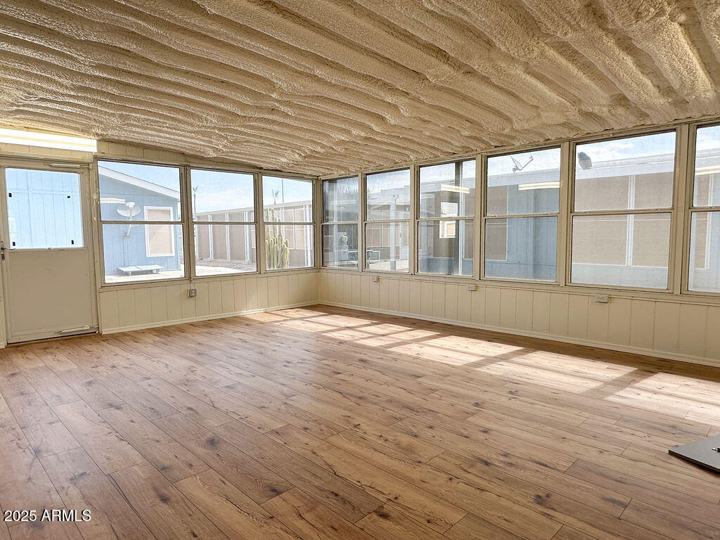 2054 North Thornton Road, Unit 187 Casa Grande, AZ 85122 - Photo 14 of 14 an empty room with wooden floor and windows