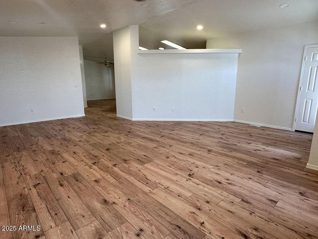 2054 North Thornton Road, Unit 187 Casa Grande, AZ 85122 - Photo 4 of 14 a view of an empty room with wooden floor and a ceiling fan