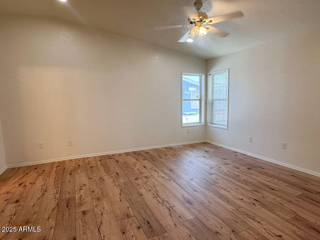 2054 North Thornton Road, Unit 187 Casa Grande, AZ 85122 - Photo 6 of 14 wooden floor in an empty room with a window