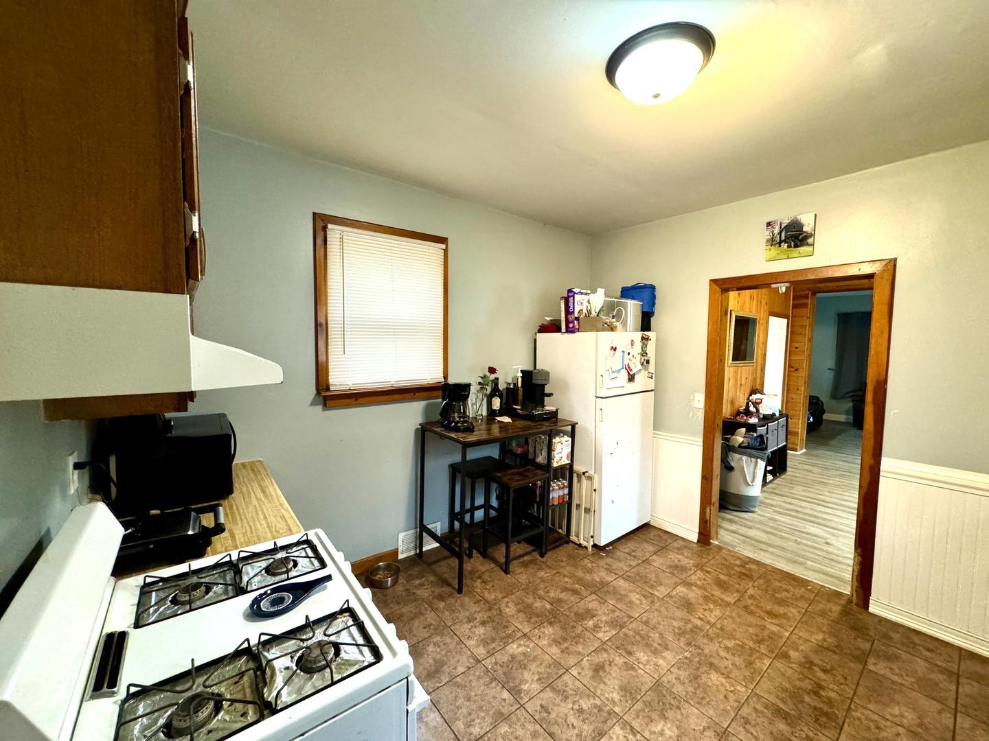 3232 Ezra Avenue Zion, IL 60099 - Photo 11 of 29 a kitchen with a stove and a refrigerator