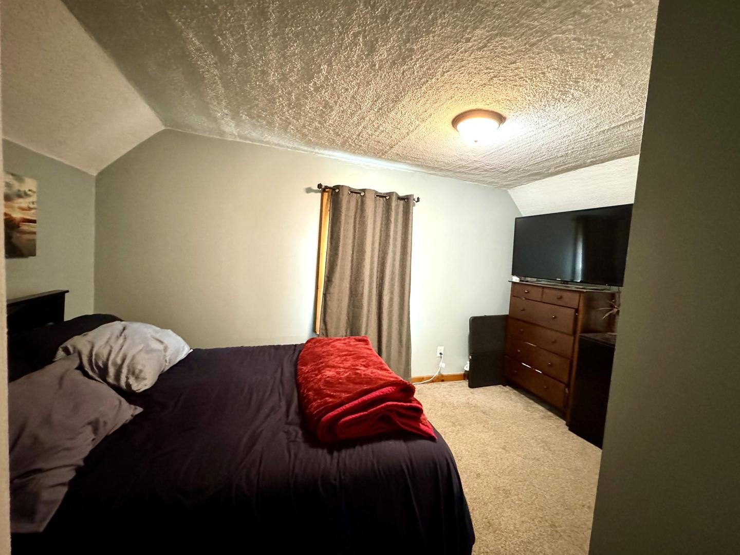 3232 Ezra Avenue Zion, IL 60099 - Photo 23 of 29 a bedroom with a bed and flat screen tv