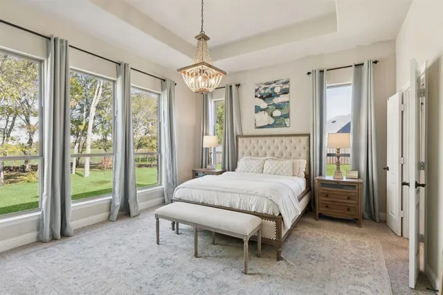 a spacious bedroom with a bed painting and a large window