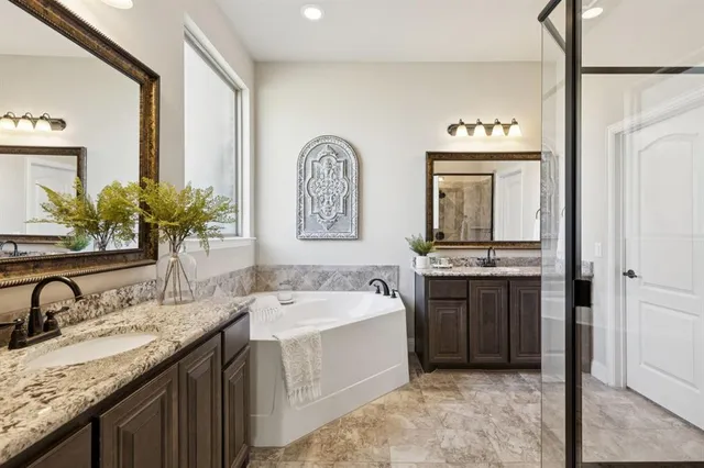 a spacious bathroom with a sink double vanity and a mirror