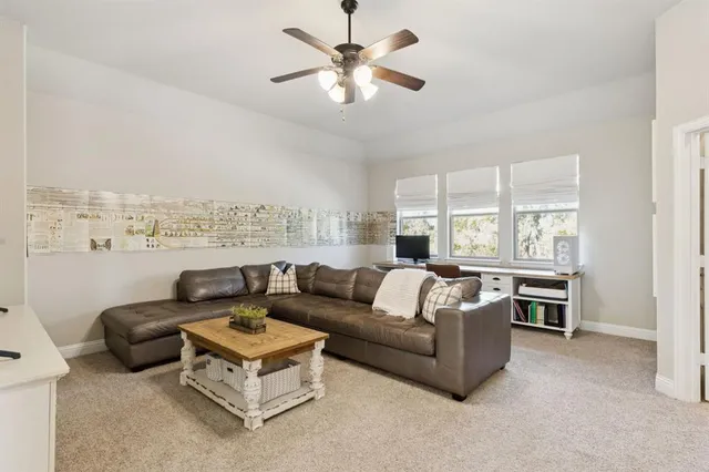 a living room with furniture fireplace and a large window