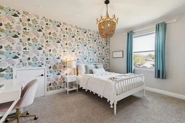 a bed room with a bed chair and a window