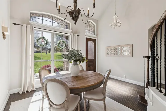 a dining room with furniture a window and wooden floor